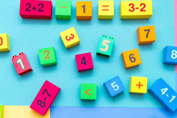 istock child kid colorful education toys cubes with numbers math pattern background on the bright background. Flat lay. Childhood infancy children babies concept. 1276396474