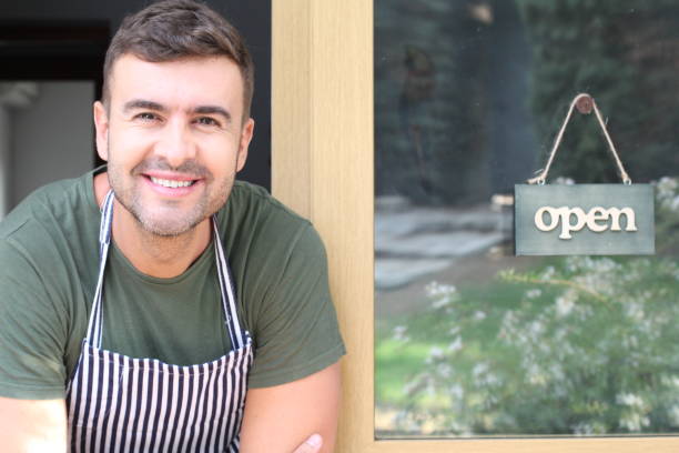 istock Cute young entrepreneur with open sign 1276396982