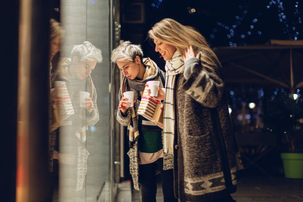 Lesbian couple Christmas window shopping. They are buying Christmas gifts. Belgrade, Serbia