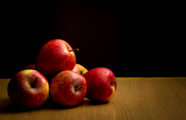 istock Juicy apples placed on a wooden table 1276397084
