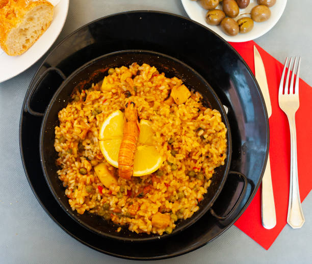 istock Seafood paella with lemon in pan 1276397200