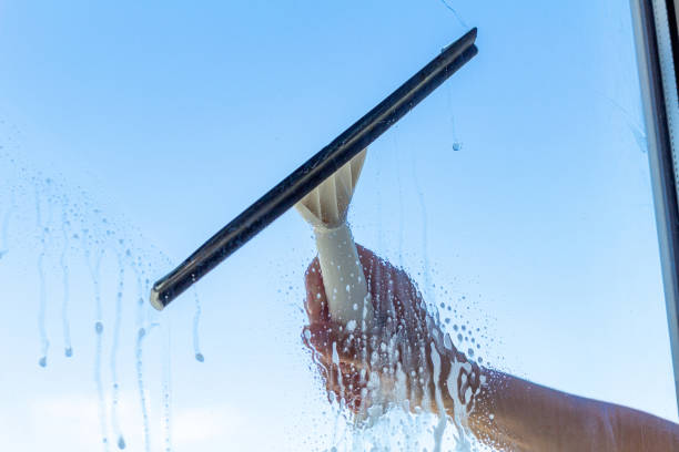 istock cleaning window with special brush on the the blue sky background 1276397555