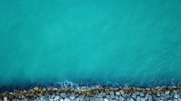 istock Aerial view of cement cube blocks protecting the shore from the waves 1276398206