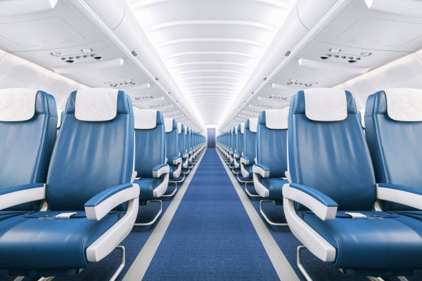 Airplane Interior Interior of a commercial airplane cabin with blue leather seats. airplane interior stock pictures, royalty-free photos & images