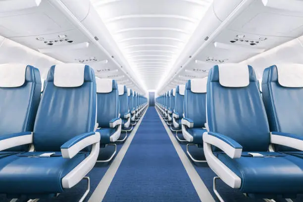 Interior of a commercial airplane cabin with blue leather seats.