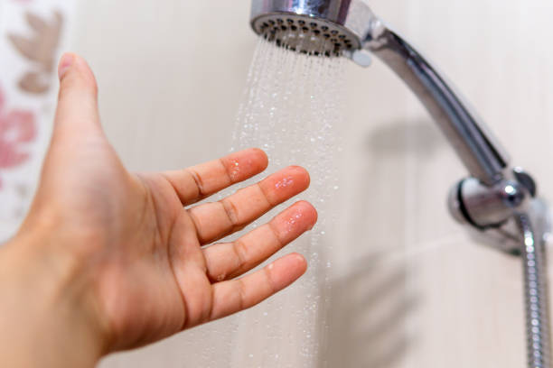 istock washing concept. Hygiene Man is checking a water temperature. 1276399666