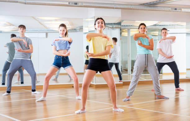 istock Teenage dancers practicing new dance in studio 1276400455