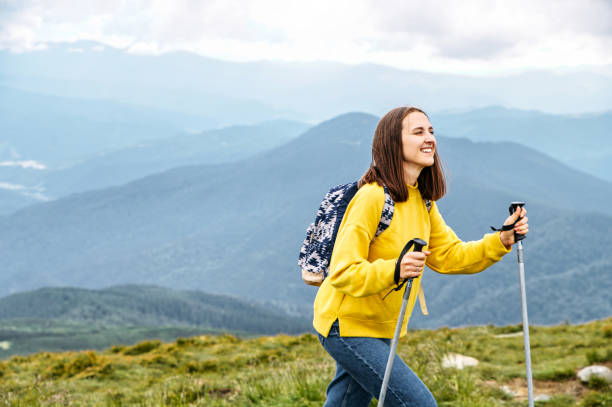 istock Female hiker with a sticks for a nordic walking 1276400876