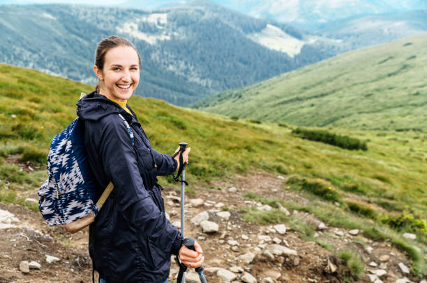 istock Female hiker with a sticks for a nordic walking 1276401086