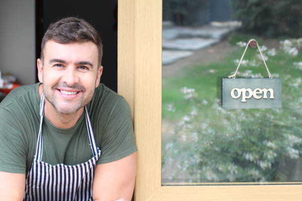 istock Cute young entrepreneur with open sign 1276401121
