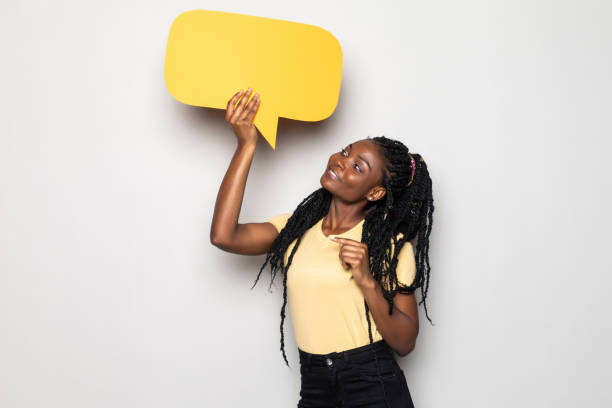 istock Young african woman holding blank speech bubble isolated on white background 1276401135