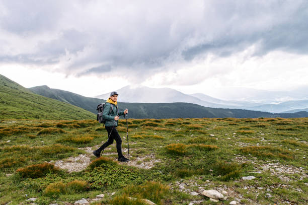 istock Backpacker guy engaged nordic walking outdoors 1276401144