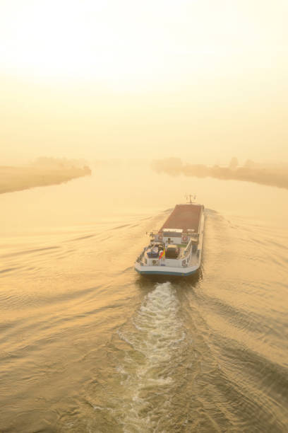 istock Ship in a sunrise over the river IJssel during a beautiful fall morning 1276401331
