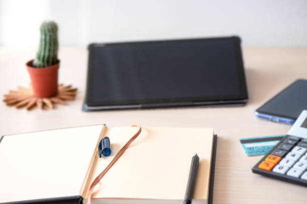 istock Close up view of freelancer workplace with blank screen tablet and empty notebook. Home office and distance learning 1276406700