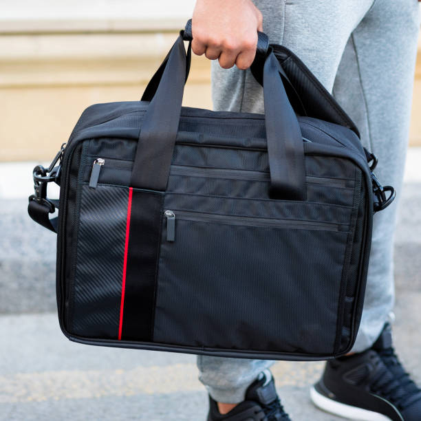istock Young man holding a black sport bag 1276407490