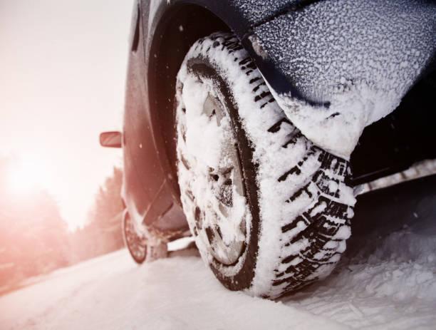 istock Car tires on winter road covered with snow 1276407515