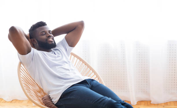 istock Young african guy relaxing at home, resting on chair 1276407603