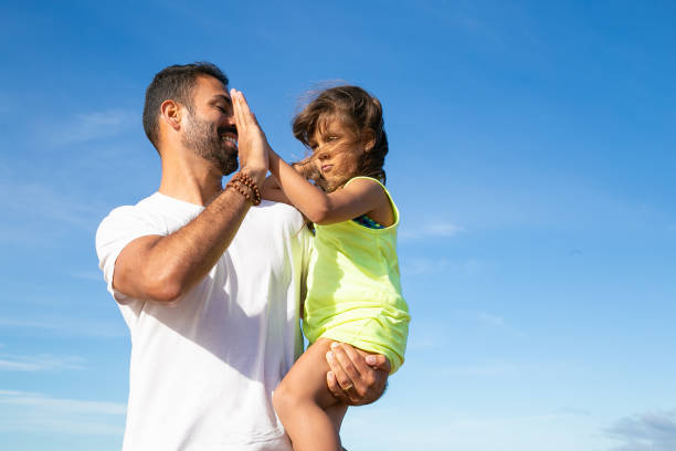 istock Joyful father holding little daughter in arms 1276408264