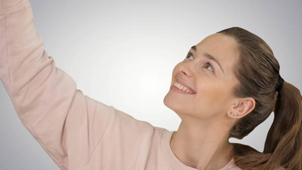 istock Smiling cheerful blond-haired woman doing selfie on gradient bac 1276408421