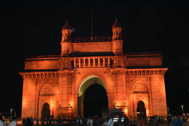 istock Glowing brown light on Gateway of india in Mumbai 1276409341