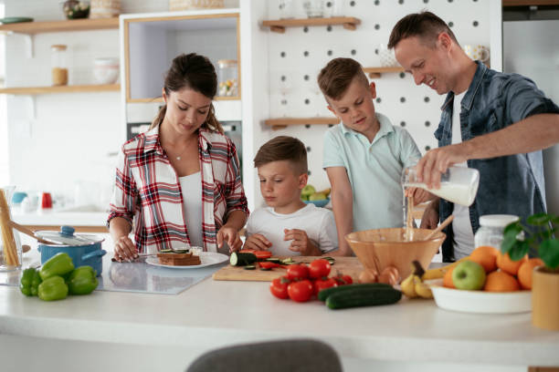 istock Young family preparing delicious food in kitchen 1276409708