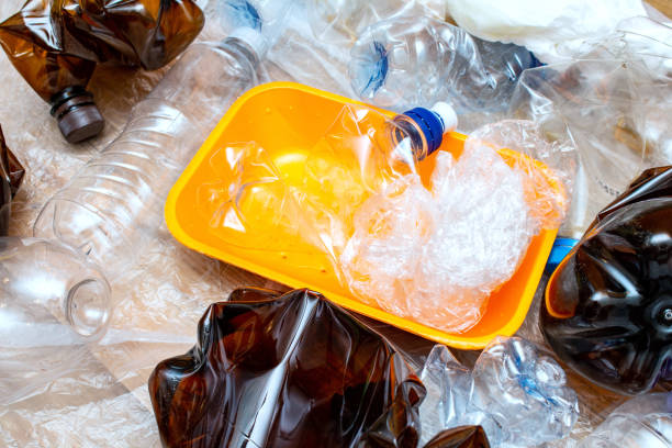 istock Lot of used plastic, orange container plate, crumpled empty bottles, packets, pollution recycle eco concept background close up selective focus 1276411555