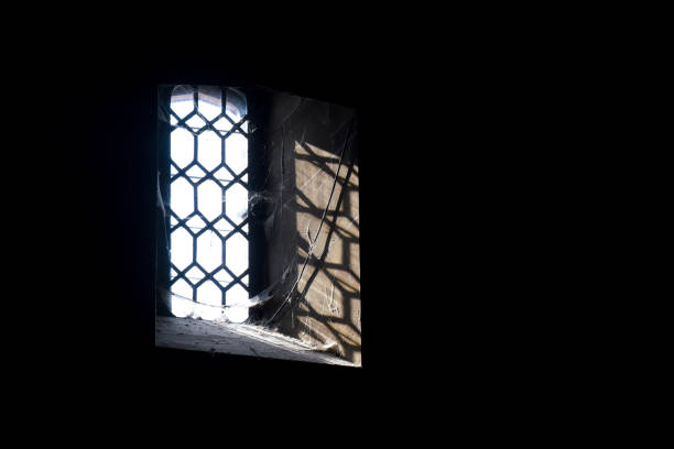 istock Haunted house window with dark shadows and cobwebs 1276416535