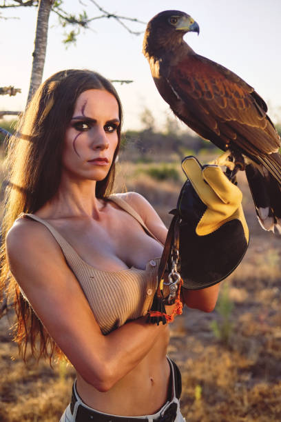 istock Beautiful woman posing on nature with eagle 1276419386