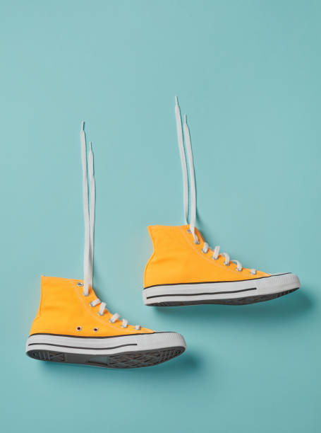 istock Yellow sneakers on blue 1276419756