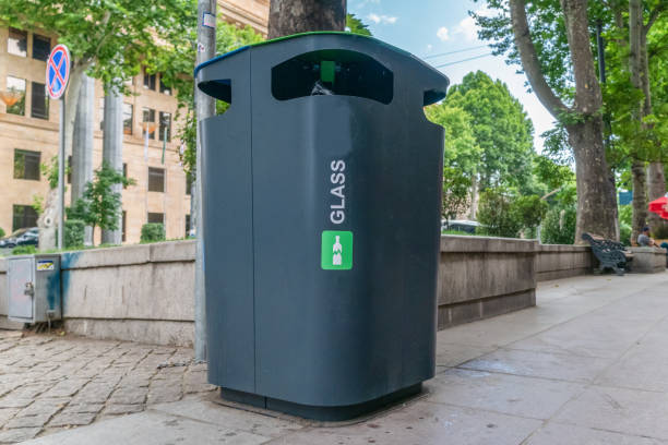 istock Glass Container Foreground. Black plastic trash bins for separate collection and sorting of paper and glass trash to protect the environment. 1276419846