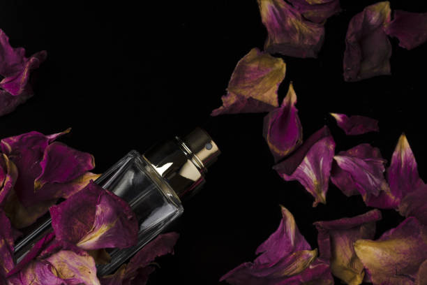 perfume bottles for men with  rose on black background