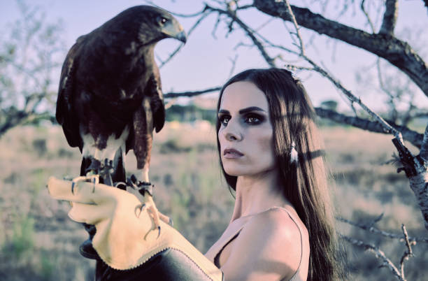 istock Beautiful woman posing on nature with eagle 1276421114
