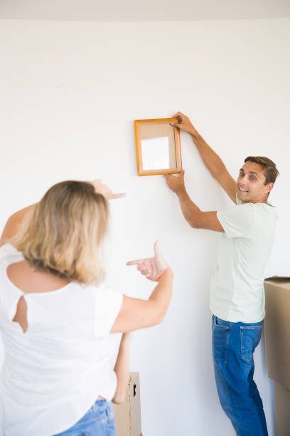 istock Happy man in casual clothes hanging up frame with copy space 1276421329