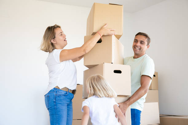 istock Happy father holding stack of boxes and smiling 1276421402