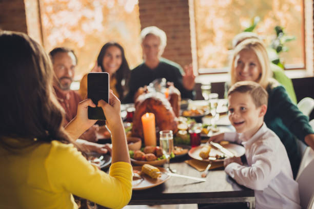 Photo of family meeting served table thanks giving dinner little girl hold telephone make portrait living room indoors Photo of family meeting, served table thanks giving dinner little girl hold telephone make portrait living room indoors virtual event photos stock pictures, royalty-free photos & images