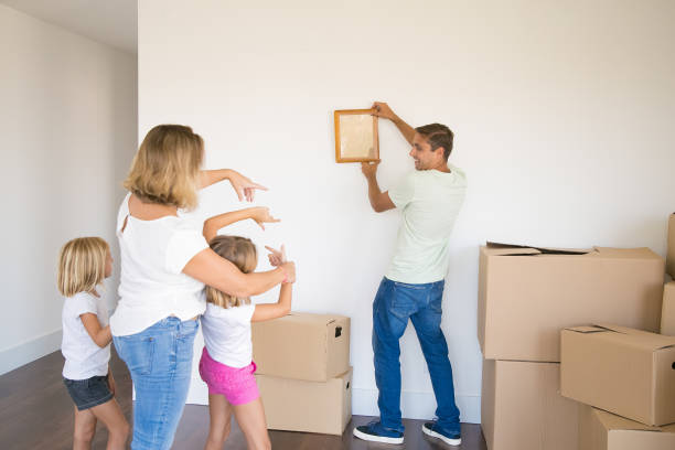 istock Caucasian dad in casual clothes hanging up empty frame on wall 1276424425
