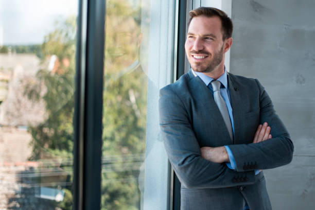 istock Success businessman standing by the window 1276424937