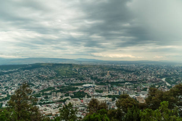 Panoramic view of Tbilisi from Mount Mtatsminda on a cloudy day, Georgia Panoramic view of Tbilisi from Mount Mtatsminda on a cloudy day, Georgia coalition building stock pictures, royalty-free photos & images