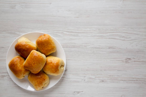 istock Home-baked Beef Russian Bierocks on a white plate on a white wooden surface, top view. Flat lay, overhead, from above. Copy space. 1276426283
