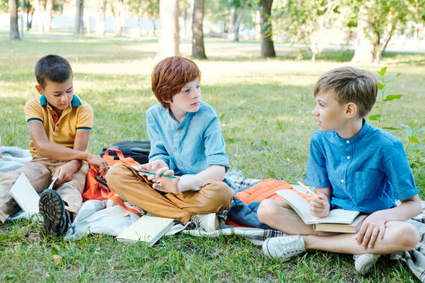 istock Boys discussing school project outdoors 1276426637