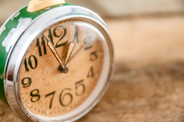 Rusted Vintage Alarm Clock on Wooden Table
