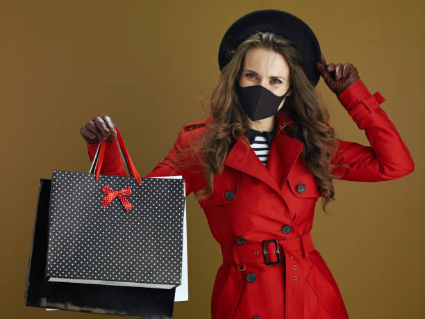 istock modern housewife in red coat against bronze background 1276428341
