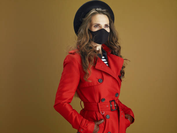 woman in coat against beige background