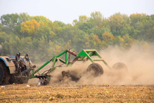 istock Farmer in tractor preparing land 1276429830