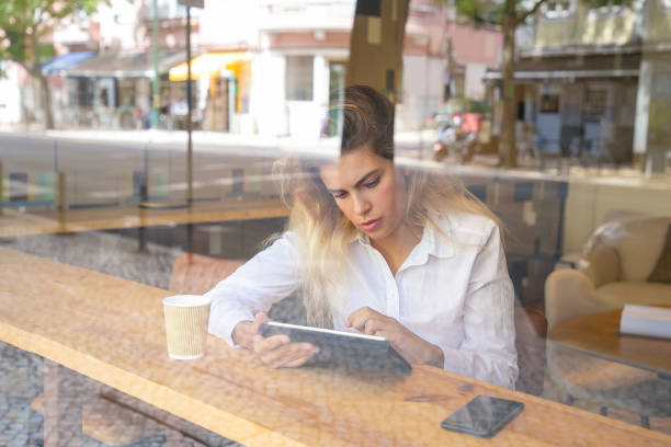 istock Focused female professional sitting at desk 1276430270