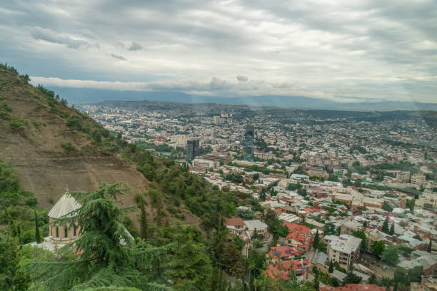 Panoramic view of Tbilisi from Mount Mtatsminda on a cloudy day, Georgia Panoramic view of Tbilisi from Mount Mtatsminda on a cloudy day, Georgia coalition building stock pictures, royalty-free photos & images