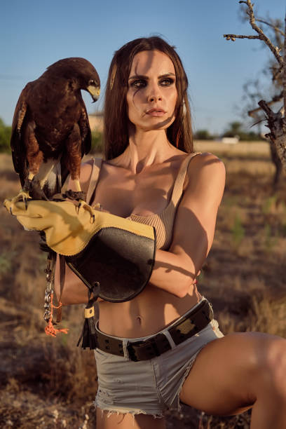 istock Beautiful woman posing on nature with eagle 1276432355