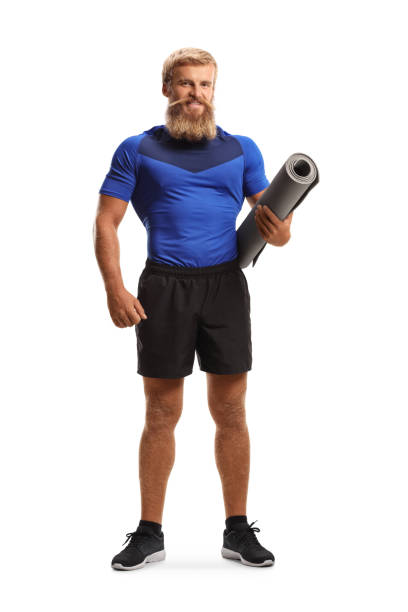 istock Young man with beard and moustache holding an exercise mat 1276432408