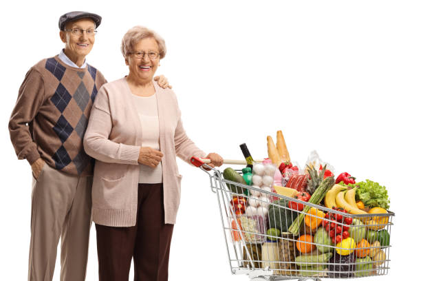 istock Mature couple posing with a shopping cart 1276432425