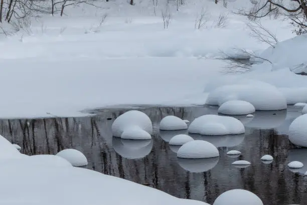 Snow mushrooms formed from heavy snow during the winter. On the River Shiribeshi, Hokkaido, Japan